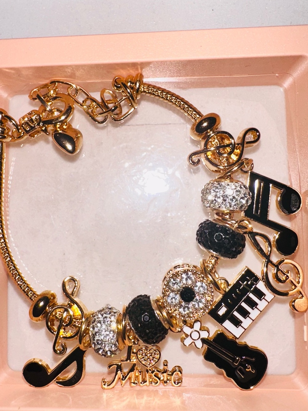 Gold-Tone Music Charm Bracelet with Black & White Accents